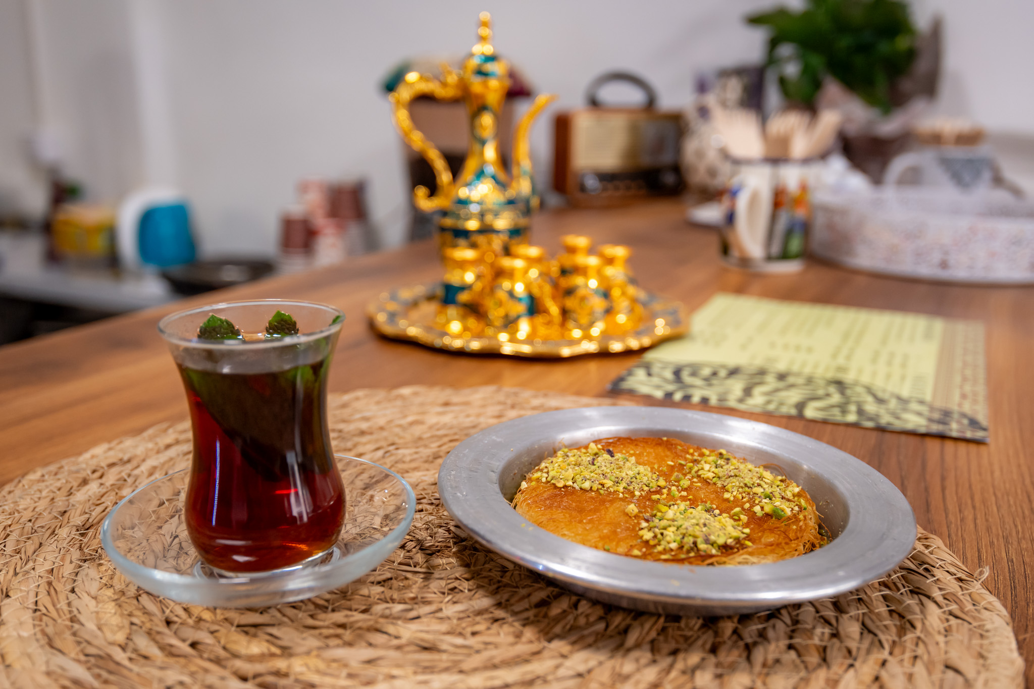 One of the bakery’s specialties is kunafa, a warm, crispy dessert soaked in syrup, pictured here served with sage tea (Photo: András Adorján)